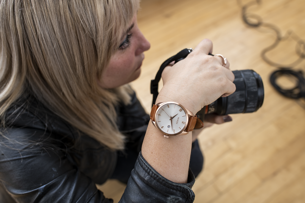 Woman photographer wears a Nixon Thalia watch