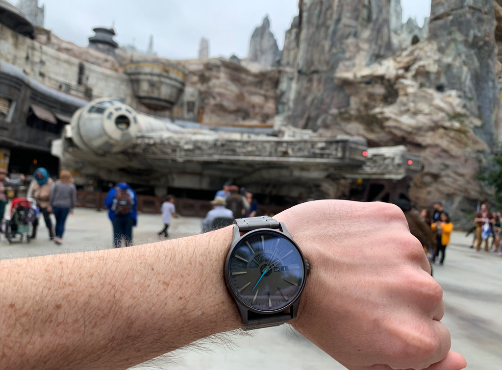 Steven wearing his Star Wars Nixon watch in front of the Millenium Falcon