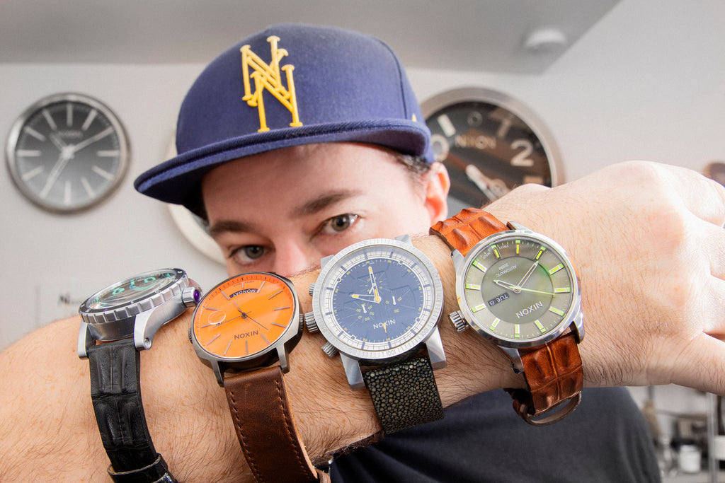 Andrew Prosser posing with some of his favorite Nixon watches