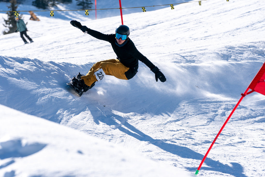 A snowboarder riding downhill at LAAX