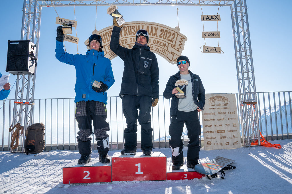 Winners pose on the podium at a LAAX snowboarding event
