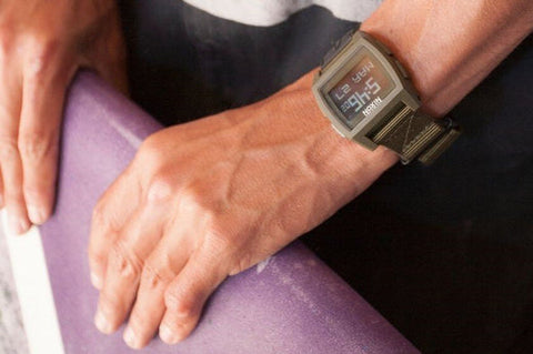 A clean nylon watch strap on a Nixon digital watch