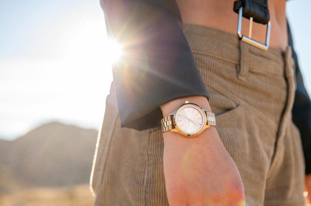 Woman wearing the Nixon Optimist Solar watch on a sunny day