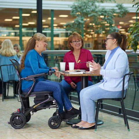 Golden Technologies Cricket Portable Folding Power Wheelchair in Restaurant