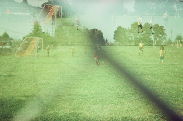 Double exposure photograph of people playing soccer