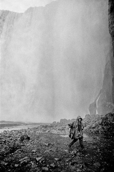 Photograph taken with Nikon F3 of person in rain jacket under a waterfall