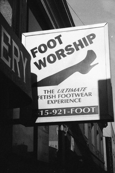 Photograph of street sign saying, "Foot Worship"