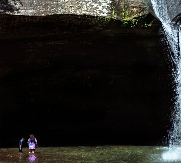 image of people under waterfall