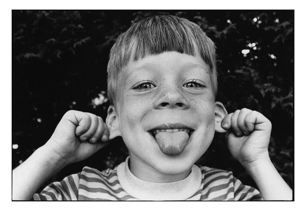 Photograph of child sticking their tongue out at the camera