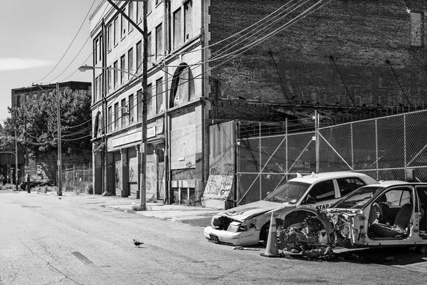 Photograph of broken cars and deserted street