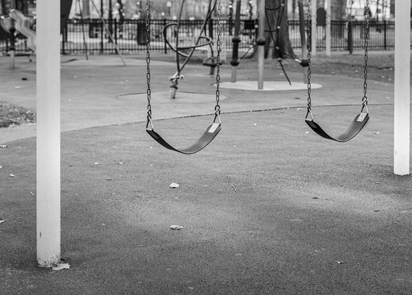 Photograph of empty swing sets