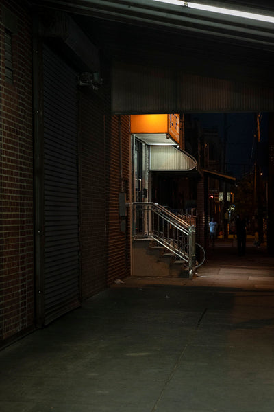 Photograph of side door entrance from street at night