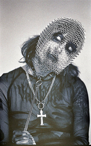 Posed photograph of person wearing a chainmail head piece