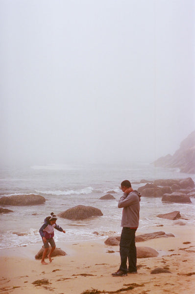 Photograph taken with a Pentax ME camera of father and daughter playing on a beach