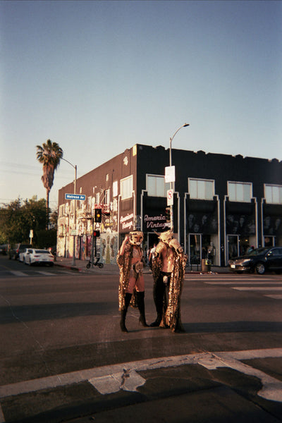 Photograph of people dressed up standing in an intersection