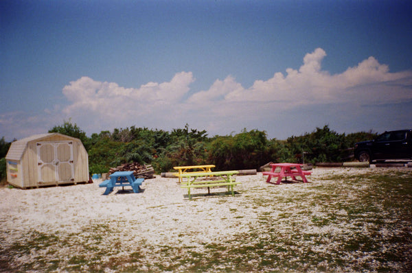 Photograph of colorful picnic tables at a campsite