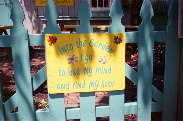 Photograph of sign on a blue fence