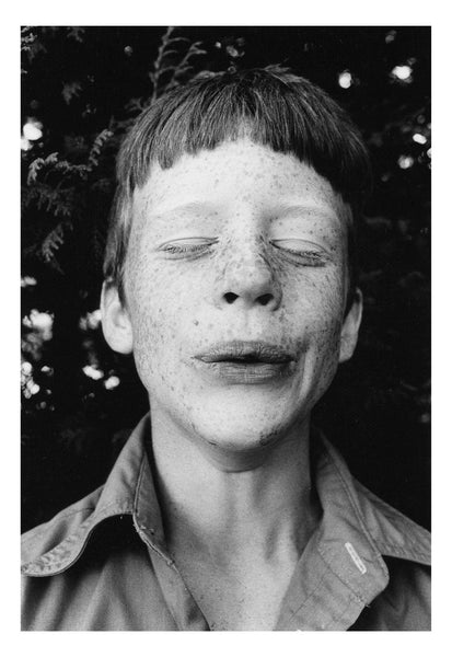 Photograph of child with their eyes closed