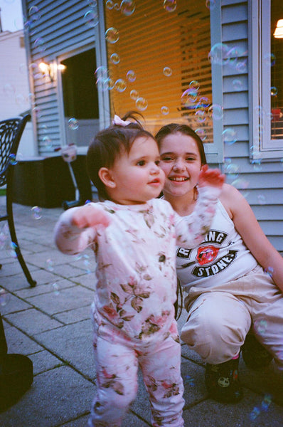 Photograph of two children with bubbles