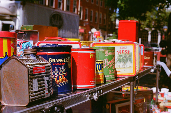 Photograph taken with a Konica Autoreflex TC of a table of cans at a flea market