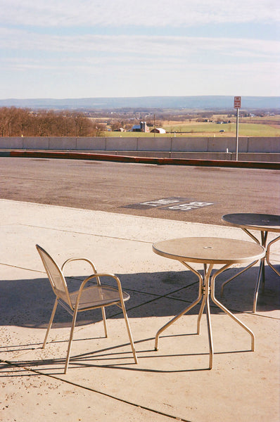 Photograph of table and chairs in parking lot