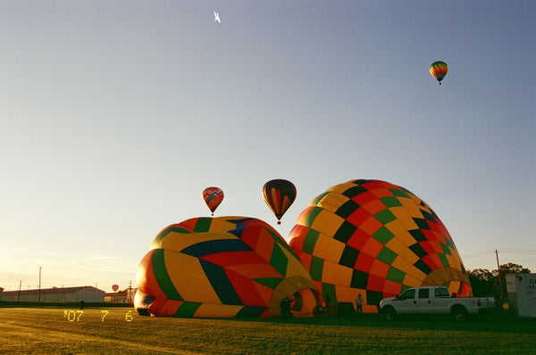 Photograph of hot air balloons deflating