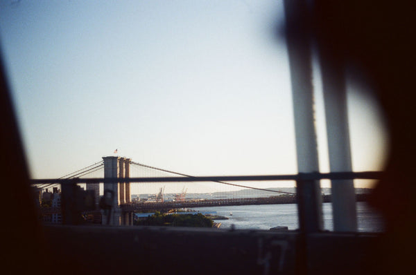 Photograph looking out a car window at the Brooklyn Bridge in New York City