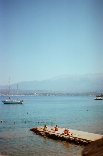 Photograph taken with a Pentax ME camera of people sitting on a dock