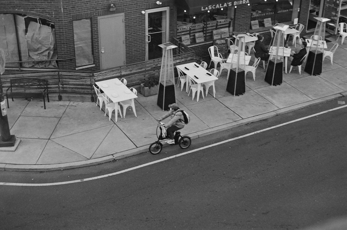 Photograph of person riding their bike in an empty street