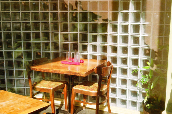 Photograph of table and chairs next to glass wall