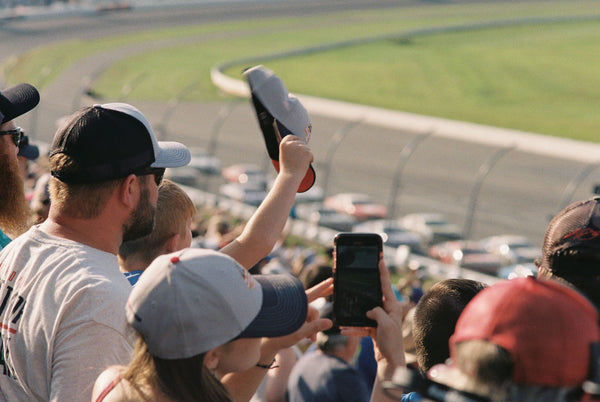 Photograph taken with a Konica Autoreflex TC of a crowd at a racetrack