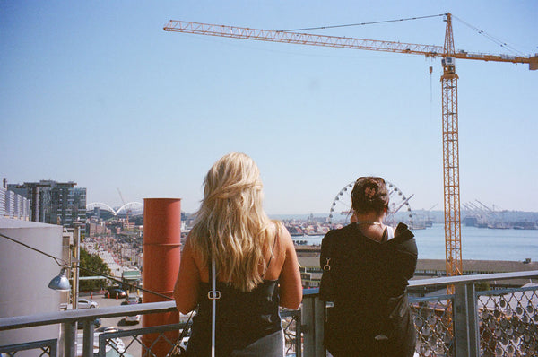 Photograph of two people looking out at a landscape