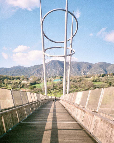Photograph looking down a bridge