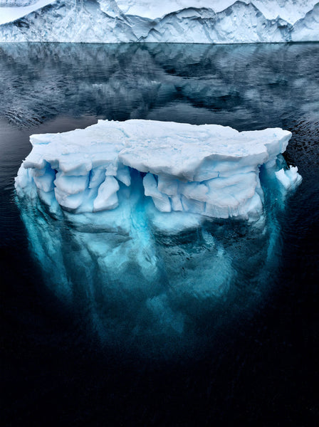 Photograph taken in Antarctica of ice berg floating in the ocean