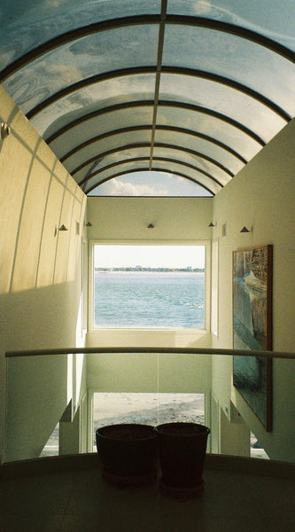 Photograph looking out a window at the ocean