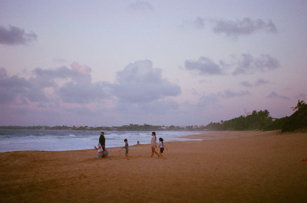 Photograph taken with a Pentax ME camera of people on a beach at sunset