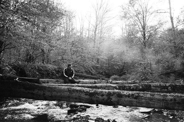 Photograph of someone sitting in a forest