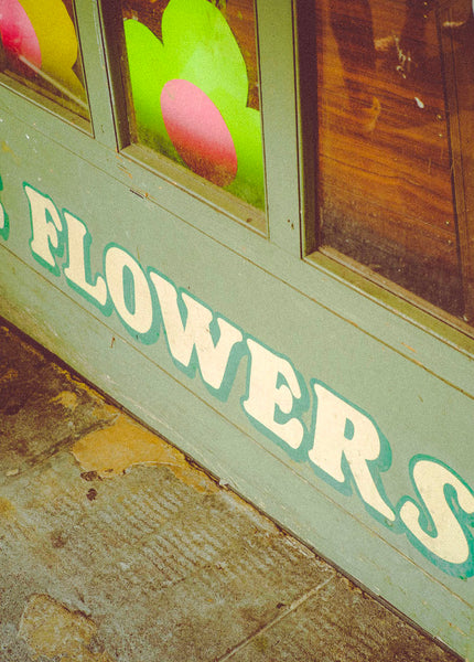Photograph of store front "Flowers" sign