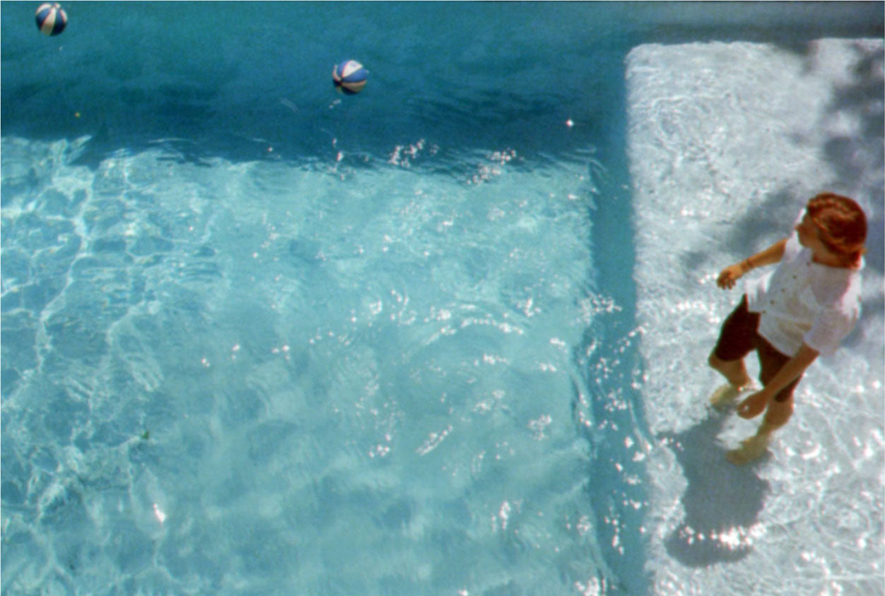 Photograph of person standing in a pool
