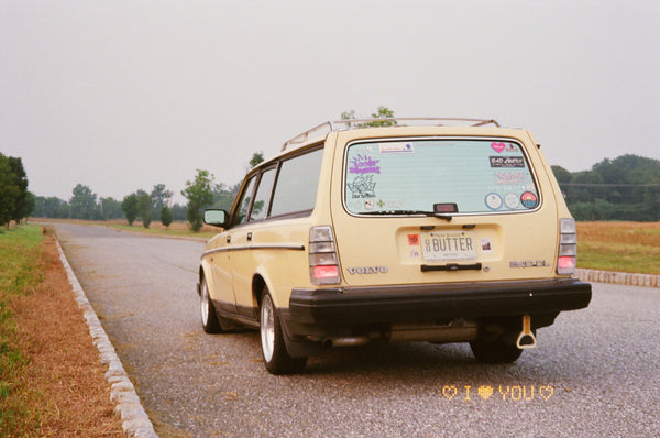 Photograph of a yellow car on a road
