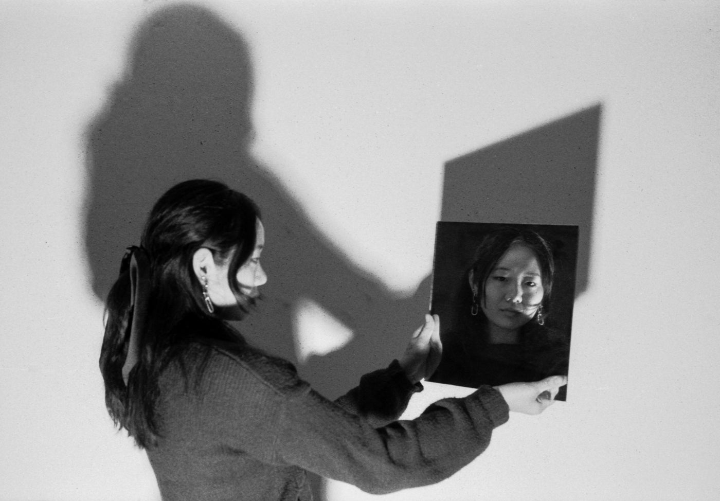 Photograph of person looking in the mirror