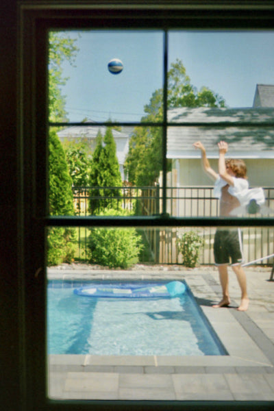 Photograph of someone throwing something over a pool