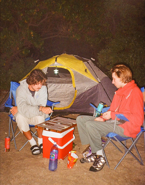 Photograph of people camping outside