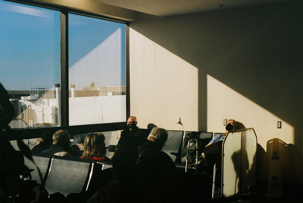 Photograph of people waiting at an airport gate