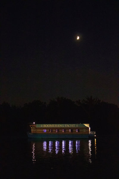 Photograph of a boat on a water way at night