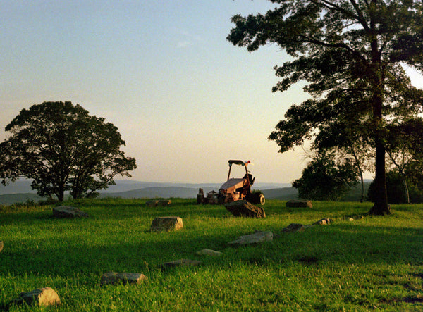 Photograph of a green landscape with a tractor