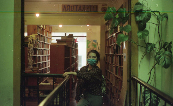 Photograph taken with a Pentax ME camera of person standing in a library