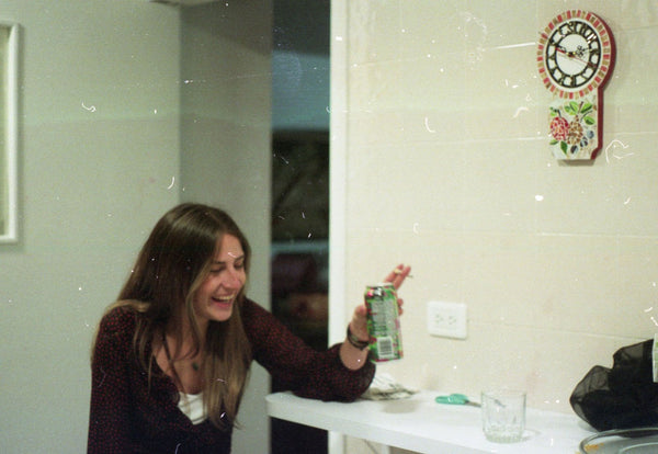 Photograph taken with a Pentax ME camera of person holding a can
