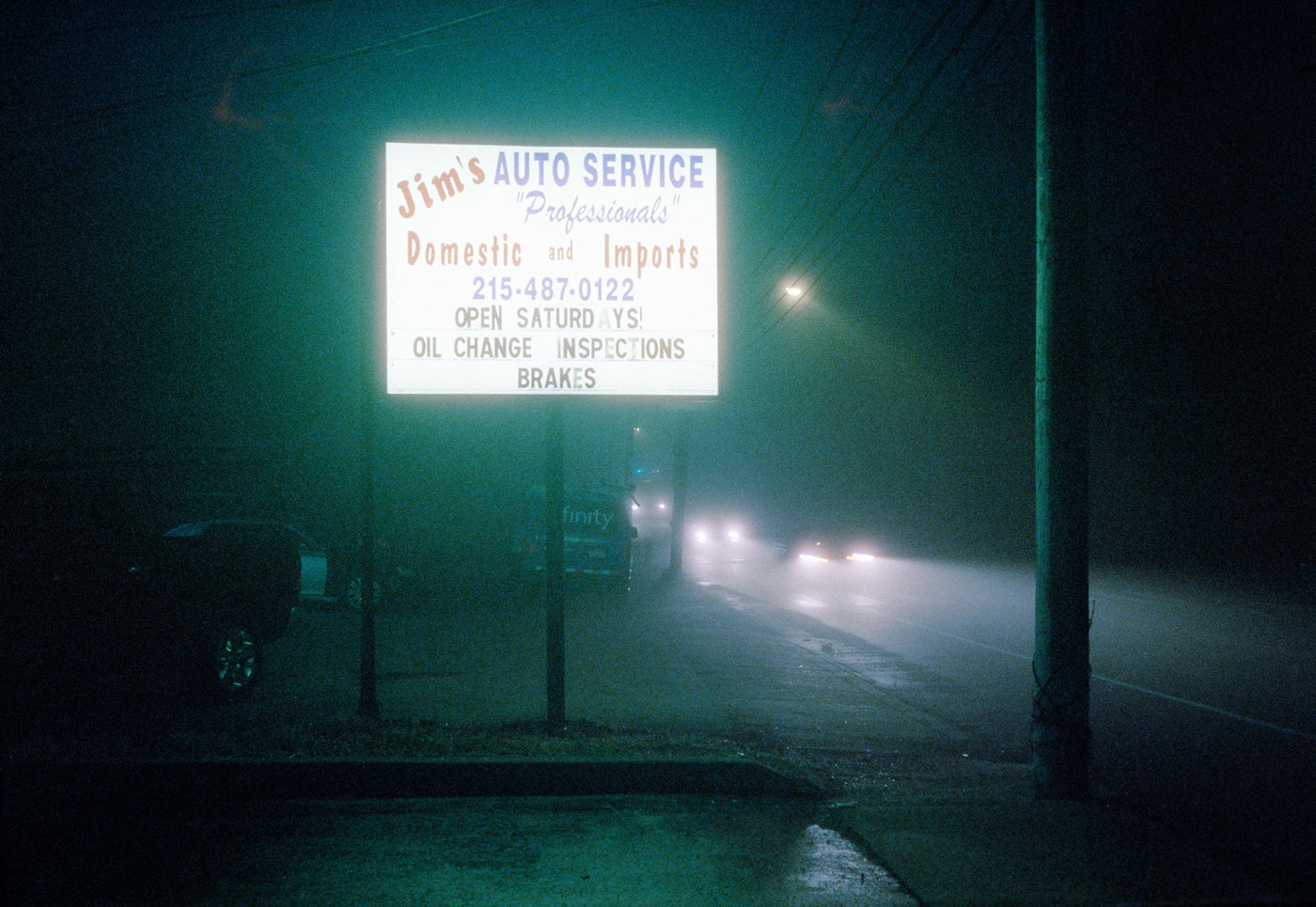 Photograph taken with Canonet QL17 GIII on Cinestill 800T film of street sign illuminated at night