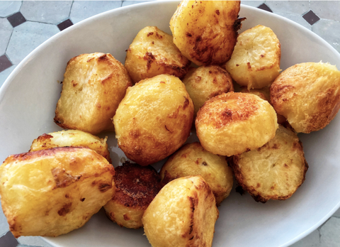 Bowl of crispy golden roast potatoes 